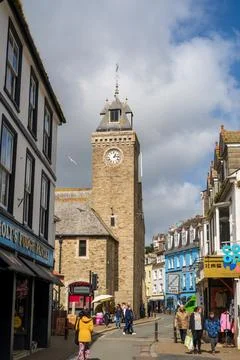 Looe Guildhall Clock Tower and Busy Street Scene Cornwall UK Stock Photos