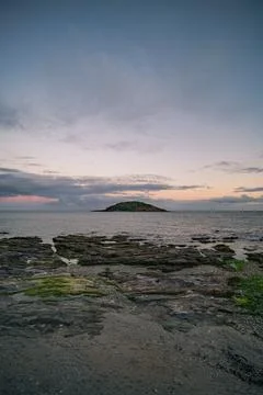 Looe Island dramatic clouds at sunset in Cornwall coastal landscape Фото