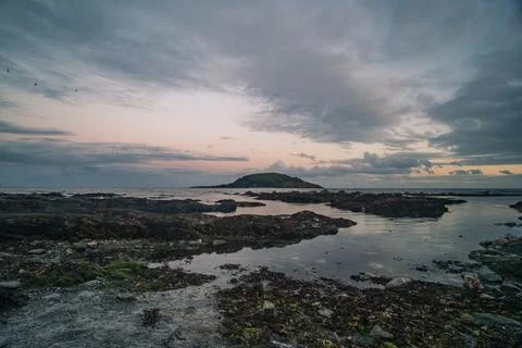 Looe Island viewed under dramatic clouds at sunset in Cornwall England Фото