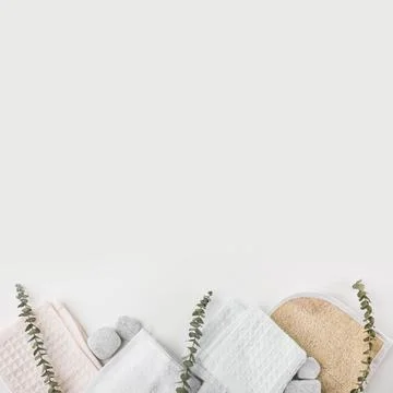 Loofah body scrub cotton napkin spa stones with twigs white background Stock Photos