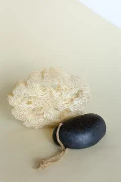 Loofah sponge and solid soap in background with copy space. Stock Photos