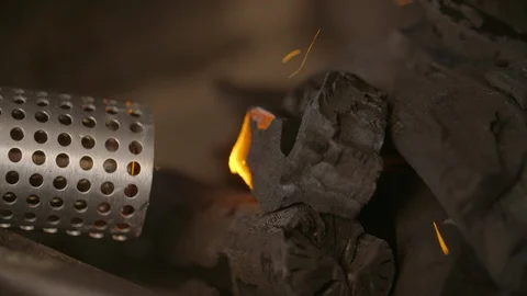 Looft lighter held against the coal to ignite fire Video stock 85965138