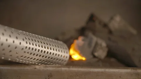 Looft lighter held against the coal to ignite fire Stock Footage 85965157