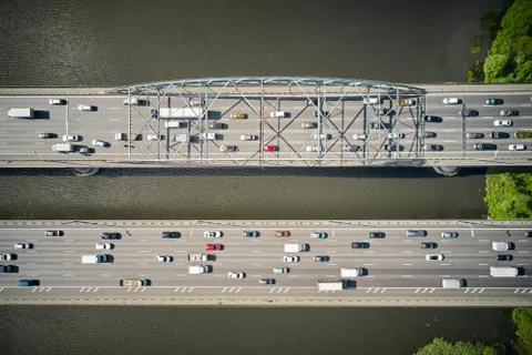 Look from above on double bridge over river. Near coast. Two parallel ways. Stock Photos