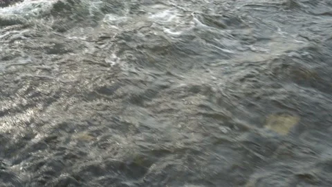 A look from above at the surface of a fast-moving river on a sunny spring day Stock Footage 149443107