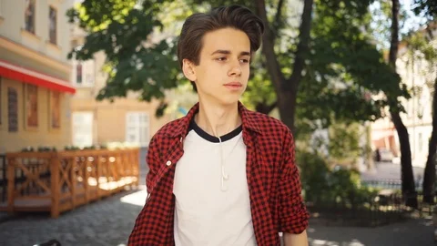 Look around boy using a mobile phone walk keeps skate guy business fashion hand Stock Footage 92050665