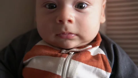 Look of baby in camera close up infant, childhood, parental love. Cute smiling Stock Footage 166324176