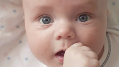The look of the baby in the camera close up shot. A cute little baby is looking Stock Footage