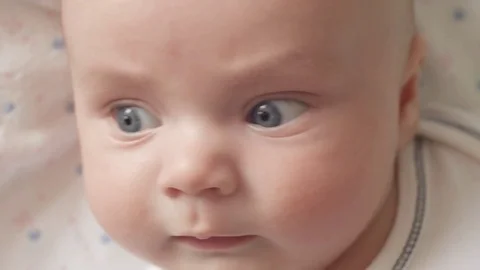 The look of the baby in the camera close up shot. A cute little baby is looking Stock Footage 76739486