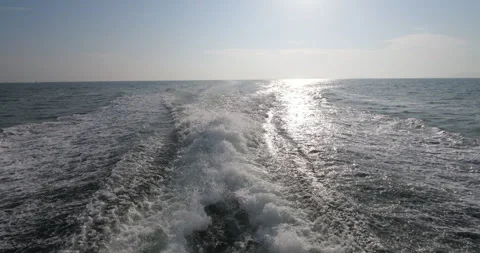 Look back from ferry sailing at full speed in sunny morning, leave wake on sea Stock Footage 314773557