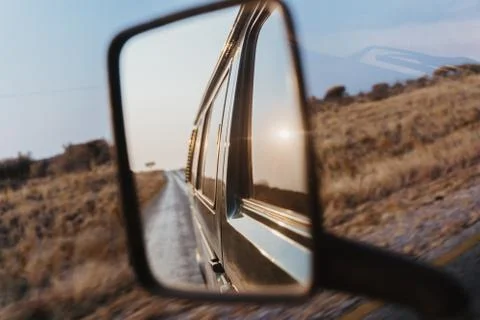 Look back into the side mirror of a van car Stock-Fotos