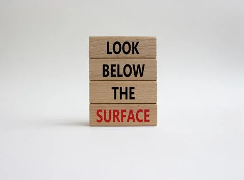 Look below the surface symbol. Concept word Look below the surface on woode.. Stock Photos