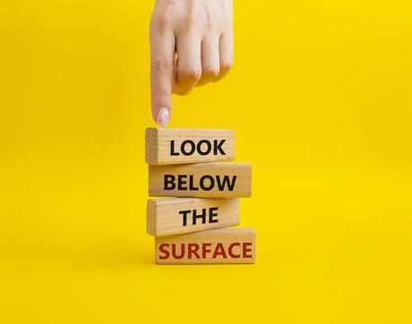 Look below the surface symbol. Concept word Look below the surface on woode.. Stock Photos
