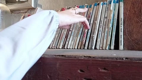 Look for books on the shelf Stock Footage 139429563