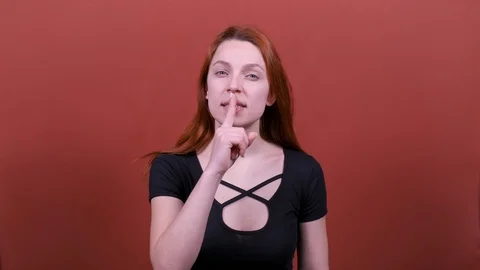 Look at camera say hush be quiet with finger on lips shhh gesture.  Stock Footage 123002285
