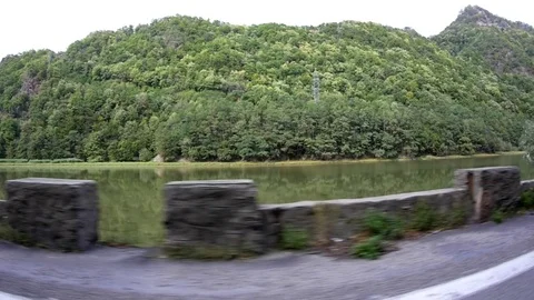 Look at the car window, the stone parapet that separates the road which work Stockbeeldmateriaal 84739837