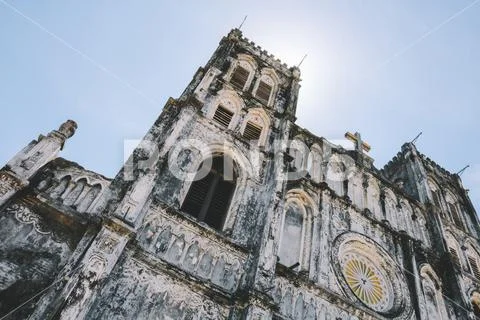 Look up detail view the Mang Lang church with cross under the sun. Stock Photos
