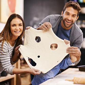 Look, a dough monster. Portrait of a happy family being playful with the pizza Stock Photos