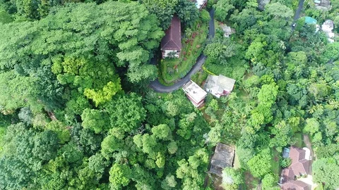 Look Down Birds Eye Fly Over a hotel surrounded by trees 4k Aerial Stock Footage 96781822