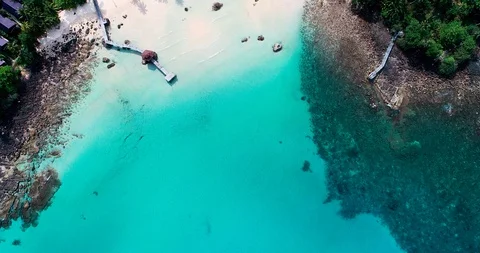 Look down view of beautiful white sand beach with turquoise sea water Stock Footage 129989908