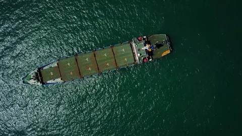 Look downwards on small bulk carrier ship in open sea, aerial shot Stock Footage 76450434