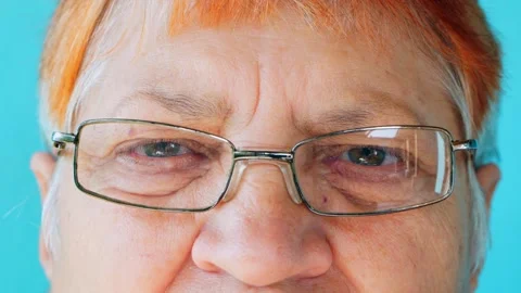 The look of an elderly 70-year-old woman with glasses and gray hair. Stock Footage 252347443