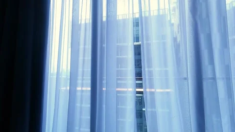 A look outside on the small balcony through the small gap of the white Stock Footage 340563113