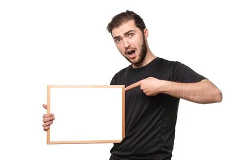 Look over there! Surprised guy with open mouth points finger space for your t Stock Photos