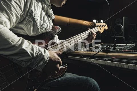 Look to play the electric guitar in a music recording studio Stock Photos