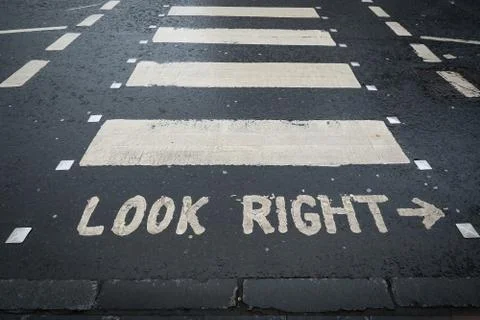 Look right. Caution road marking for pedestrians shows direction of approachi Stock Photos