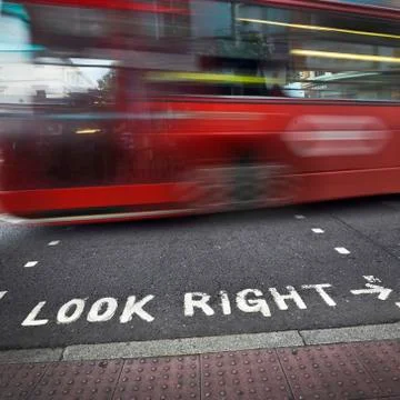 Look Right Sign at Crosswalk and Speeding Double Decker Bus, London, England, UK Stock Photos