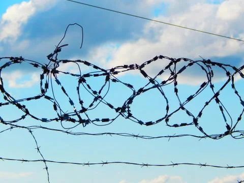 Look at the sky through a barbed wire Stock Photos