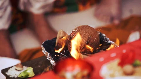 Look from the table with petals at cocounut burning in the bowl Stock Footage 68668787