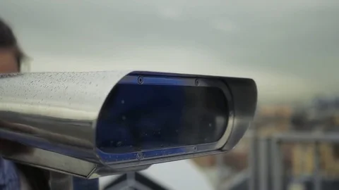 To look through binoculars to the city in cloudy weather. HD, 1920x1080. slow Stock Footage 78963605