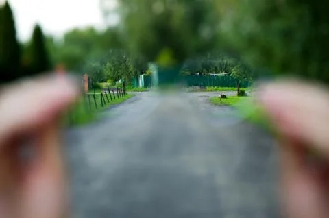 Look through glasses on a rustic view. Oblique fences, forest, grass are clea Stock Photos