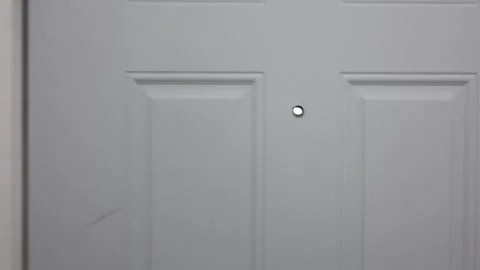 Look through the peephole door Stock Footage 310859550