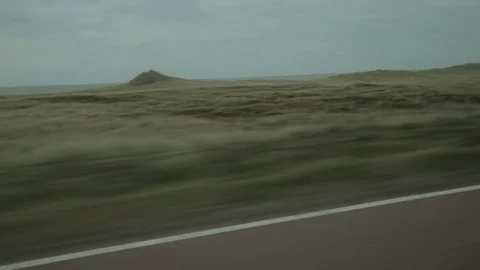 Look through side window of driving car through Denmark landcape Stock Footage 77030803