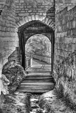 A look thru an opened stone gate of an ancient fortress Foto stock