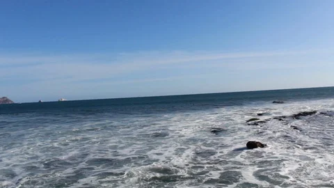Look towards the blue ocean with waves and rocks Stock Footage 119281750