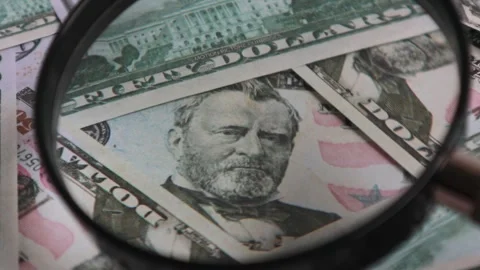 Look using a magnifying glass at the stack of 50 dollar bills Stock Footage 302849354