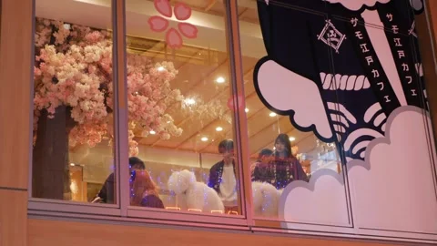Look up view to giant glass window of Dog cafe with many dogs and people ha.. Vídeos de archivo 335584428