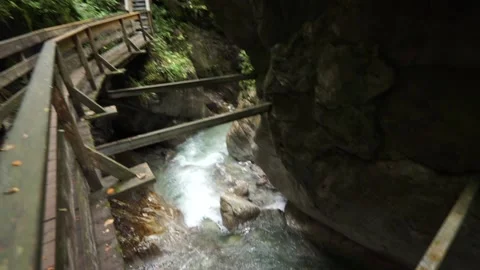 Look on a wild river in a gorge seen from a wooden bridge Stock Footage 218355201