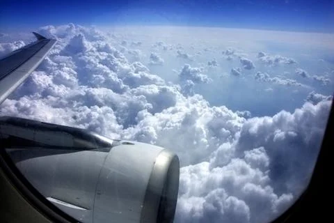 Look from windows aboard a plane on blue sky with clouds Stock Photos