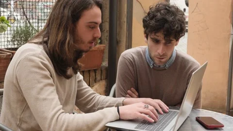 Look for work - young friends intent on writing a cover letter with the laptop Video stock 225452080