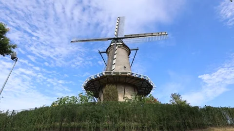 Looking up at 18th century stone tower windmill with clouds passing by Stock Footage 341876521