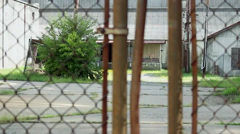 Looking at abandoned factory through rusty gates Vídeo Stock 54100279