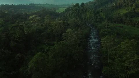 Looking from above, a stream is flowing from the top of the mountain to the s Stock Photos