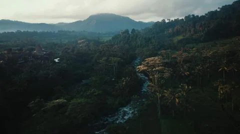 Looking from above, a stream is flowing from the top of the mountain to the s Stock Photos