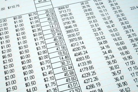 Looking at the accounts on a printed spreadsheet. Fotos Stock