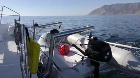 Looking aft of the catamaran a fully loaded and ready shore dinghy Stock Footage 67970879